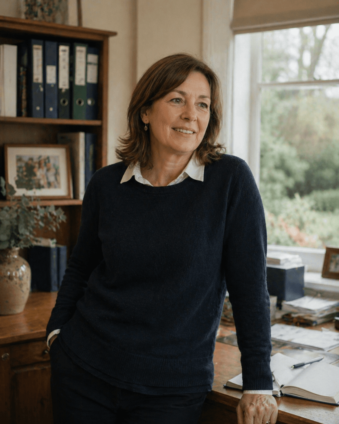A carer and an elderly resident sharing a smile and a moment of conversation in a communal area.